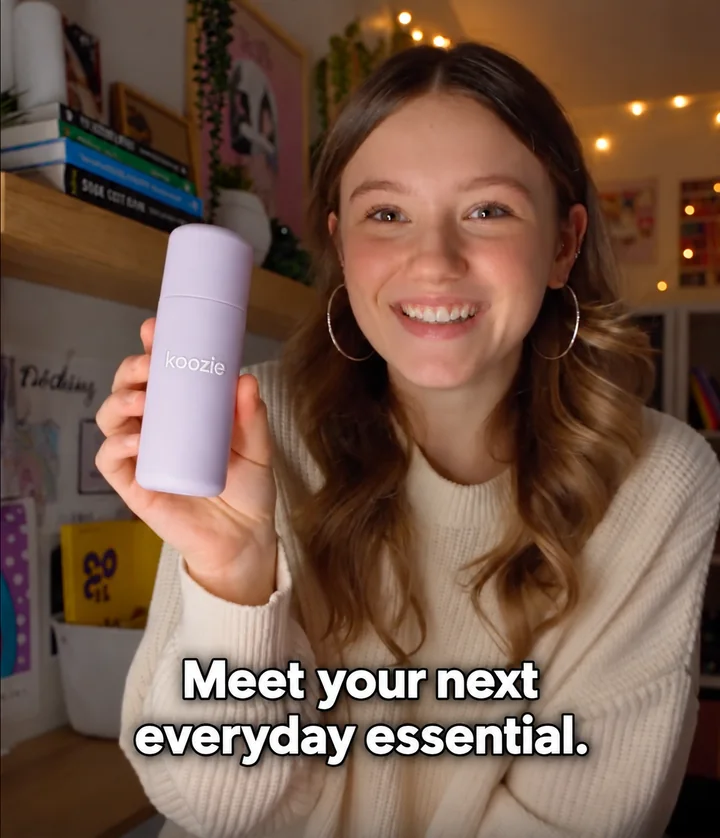 Woman holding a lavender Koozie bottle in a product ad